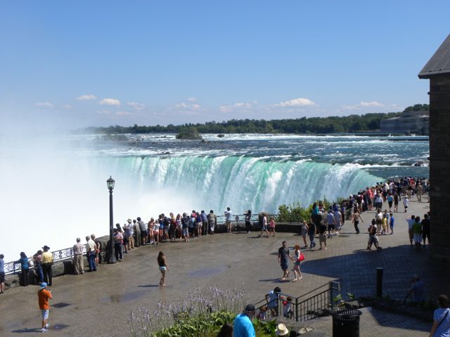 Line of people looking at panorama of all three falls.